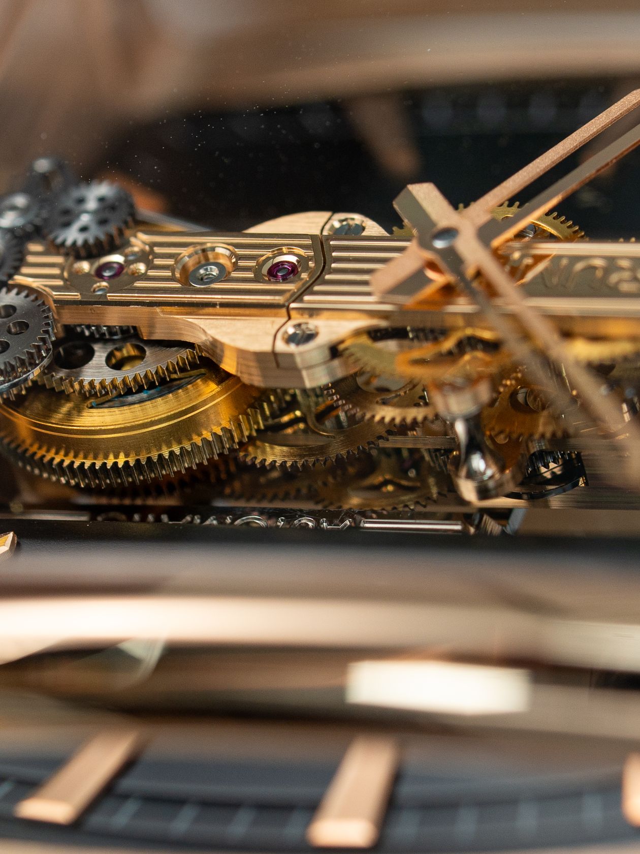 Close-up of a mechanical watch movement showing intricate golden gears and components