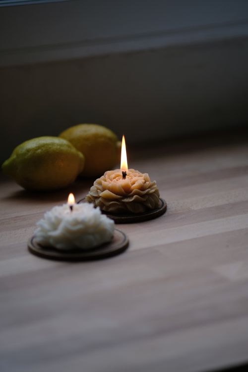 Free Soothing candlelit arrangement with lemons on a wooden surface, perfect for relaxation themes. Stock Photo