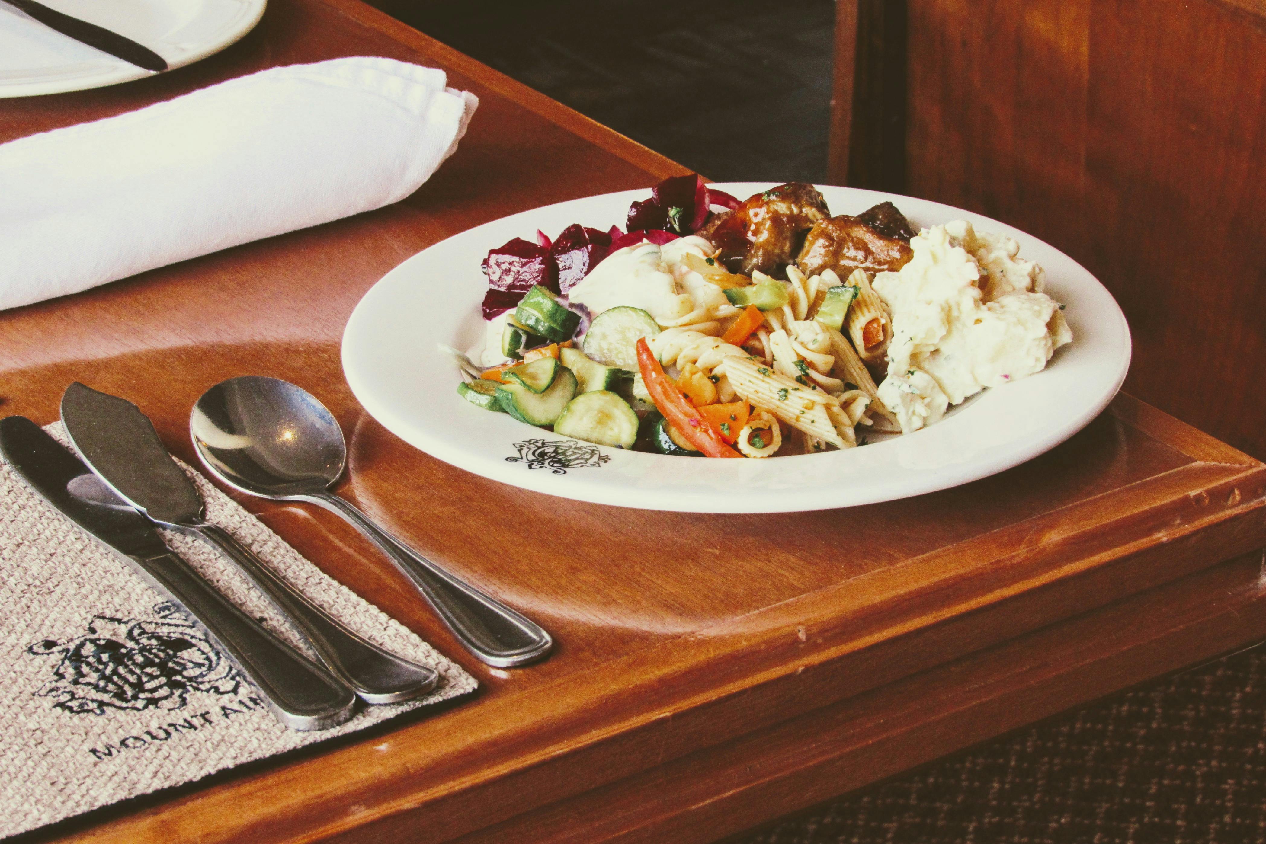 A tempting plate of mixed salad and pasta served at a cozy restaurant.