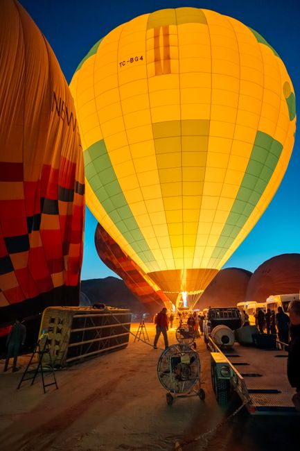 Stunning view of hot air balloons illuminated before sunrise in Cappadocia, Türkiye.