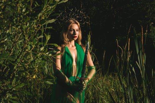 Captivating fantasy-themed portrait of a woman in green attire holding a sword in a lush forest setting.