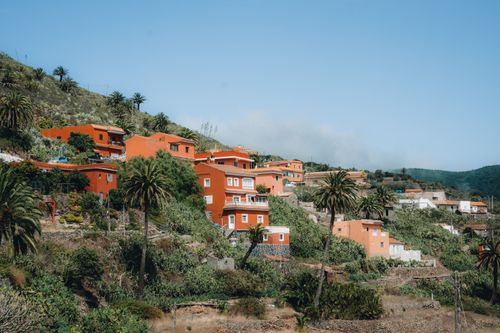 Free Picturesque hillside village with colorful houses in Arure, Canary Islands. A soothing summer day vibe with lush greenery. Stock Photo
