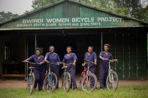 Free Women at Bwindi Bicycle Project empowering community through cycling initiatives. Stock Photo