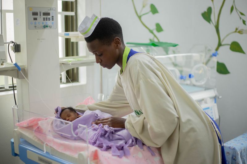 Nurse caring for a newborn in a hospital nursery