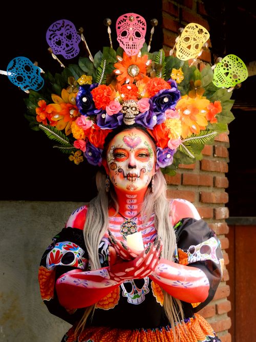Free Colorful Catrina with floral headpiece celebrating Día de Muertos in Mexico City. Stock Photo