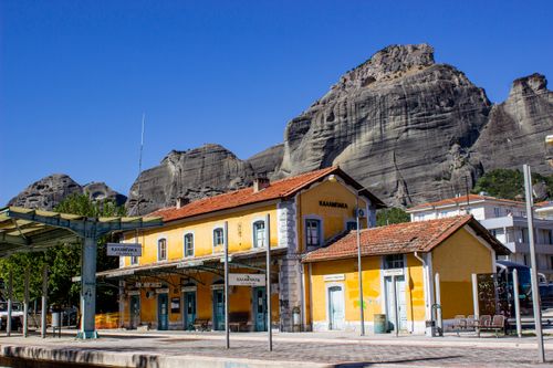 Free Kalamaka Railway Station in Greece with Meteora rock formations in the background. Stock Photo