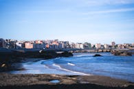 充满活力的沿海城市景观，在蔚蓝的天空下，有沙滩和岩石