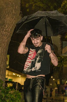 A stylish young man holding an umbrella in a rainy urban street at night in Argentina.