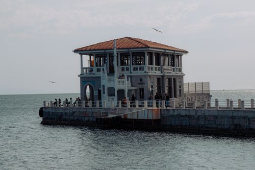 Free Explore the historic Moda Pier in İstanbul with views of the Marmara Sea, capturing local life and architectural charm. Stock Photo