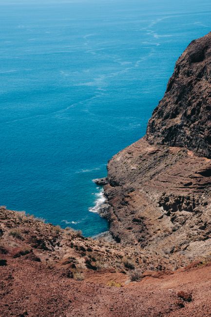 Scenic view of the rugged cliffs meeting the clear blue Atlantic in Alajeró, Canary Islands.