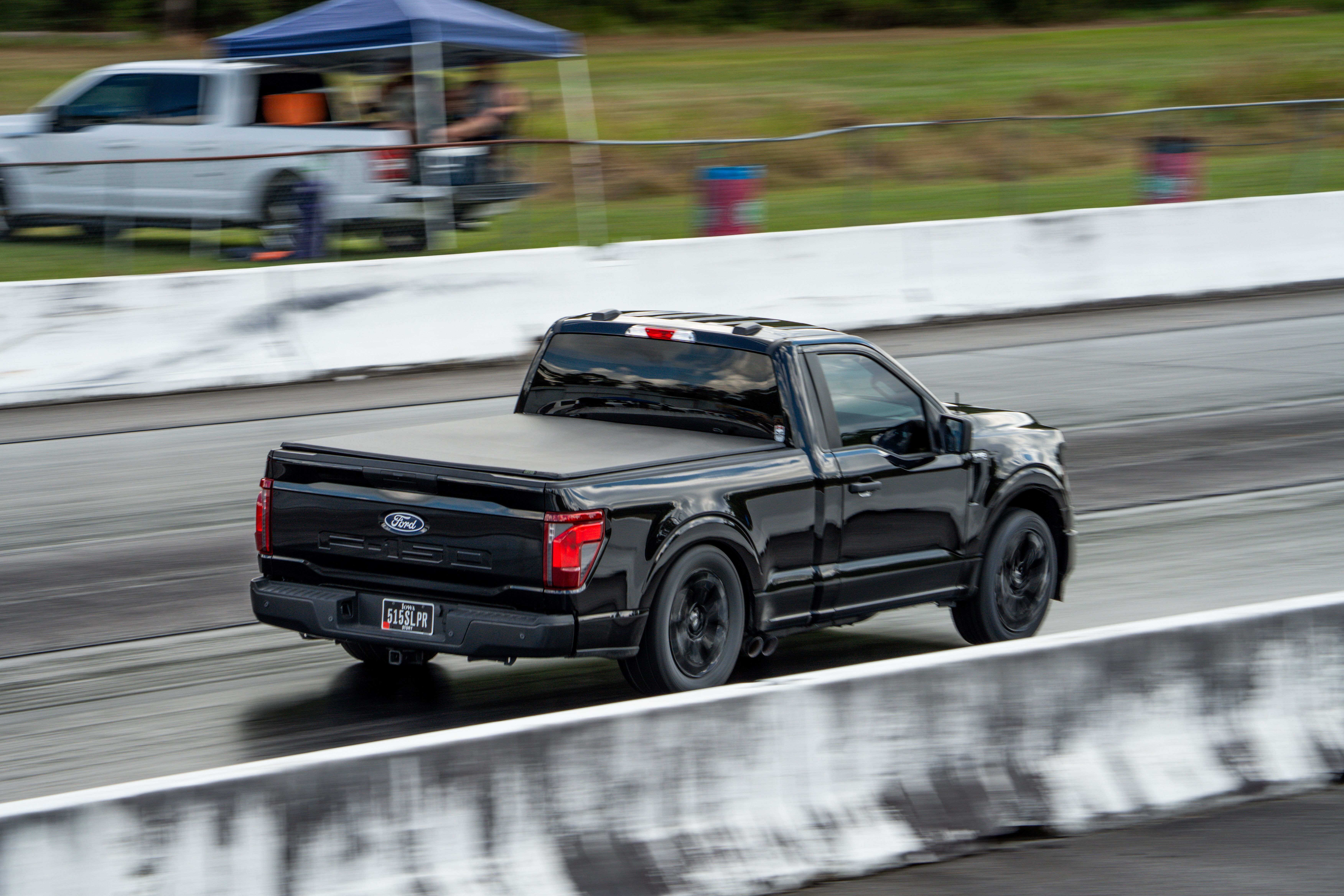 Black Pickup Truck Racing on Outdoor Track · Free Stock Photo