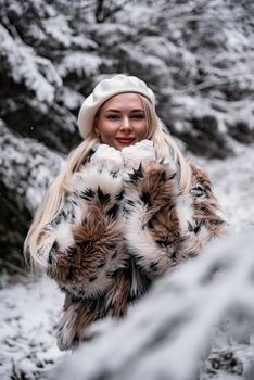 Elegant woman in a faux fur coat enjoying snowy winter outdoors.