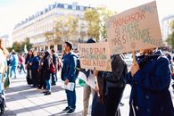 Crowd gathering for a peaceful protest in Paris, raising awareness about Madagascar's political issues.