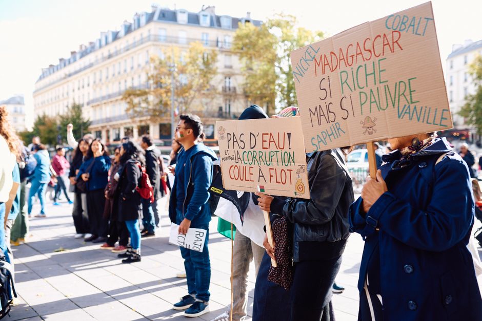 Crowd gathering for a peaceful protest in Paris, raising awareness about Madagascar's political issu