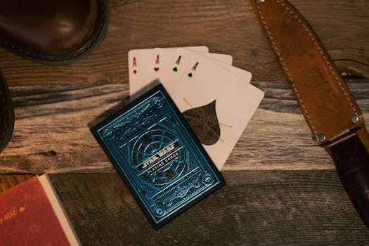 Star Wars themed playing cards with a vintage knife on a wooden table.