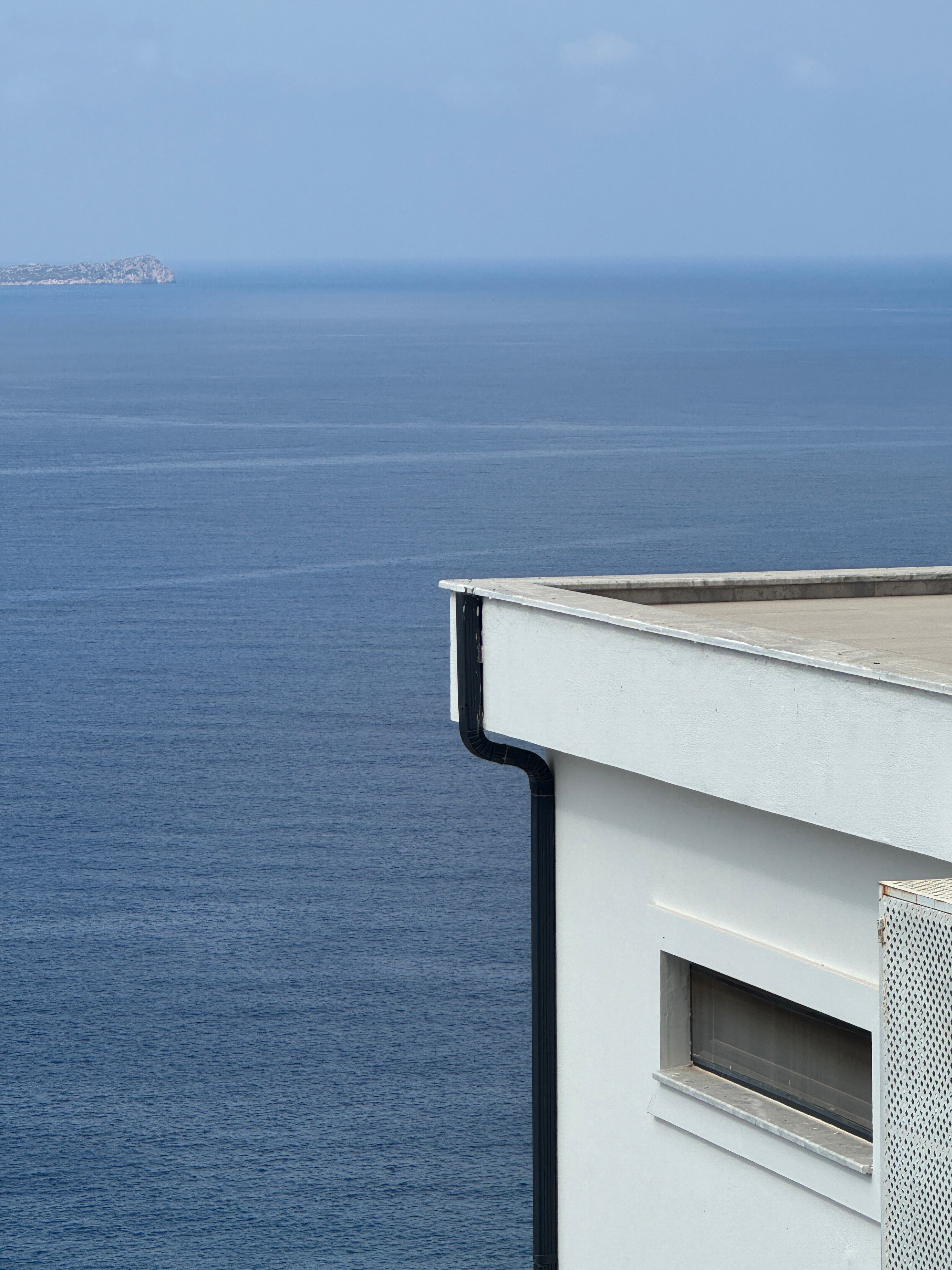 Modern Oceanfront Building with Serene Sea View · Free Stock Photo