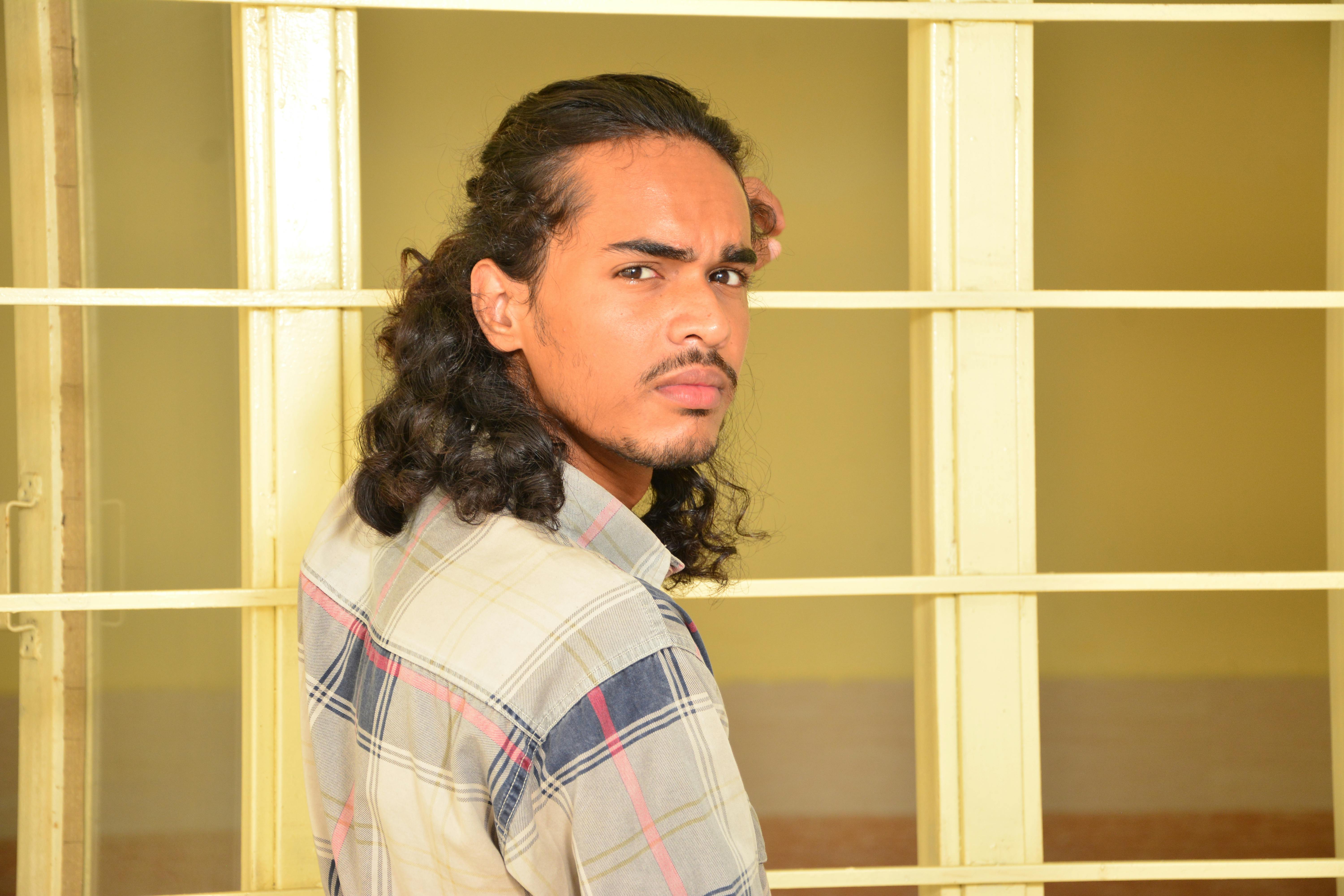 Portrait of Young Man with Long Curly Hair · Free Stock Photo