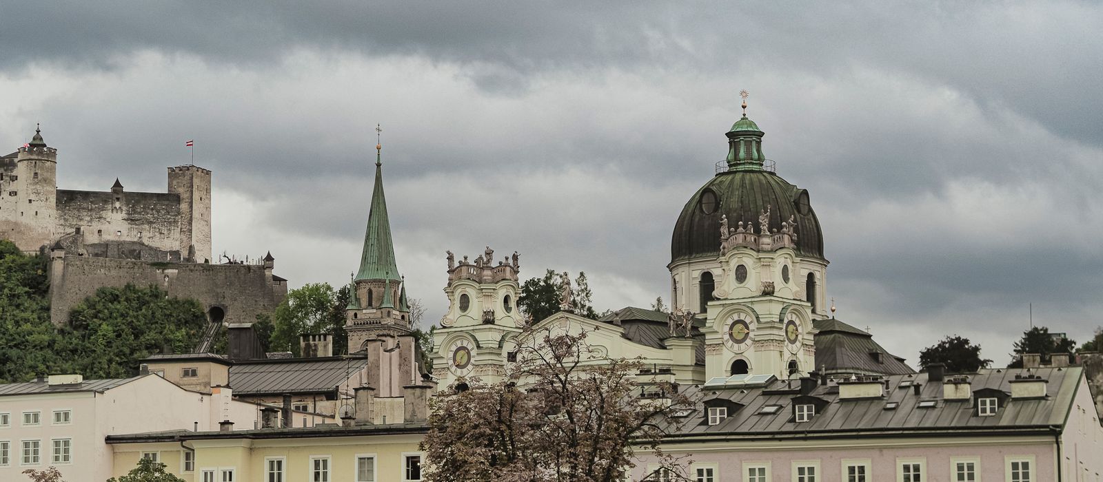 Explore the architectural charm of Salzburg's Dom Quartier with Hohensalzburg Fortress in the backdrop.