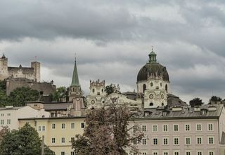 Explore the architectural charm of Salzburg's Dom Quartier with Hohensalzburg Fortress in the backdrop.