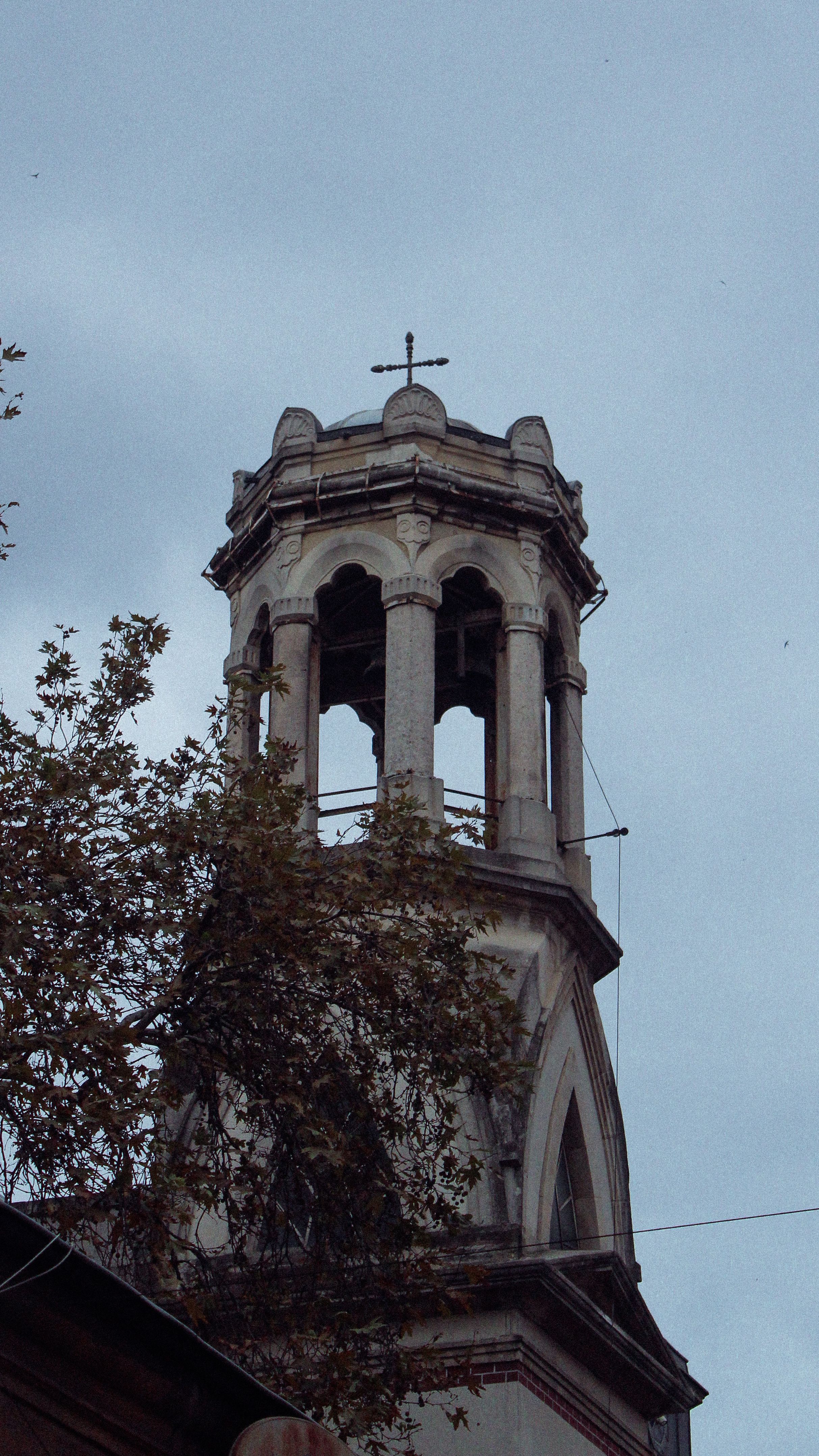 Historic Church Bell Tower with Cross at Dusk · Free Stock Photo