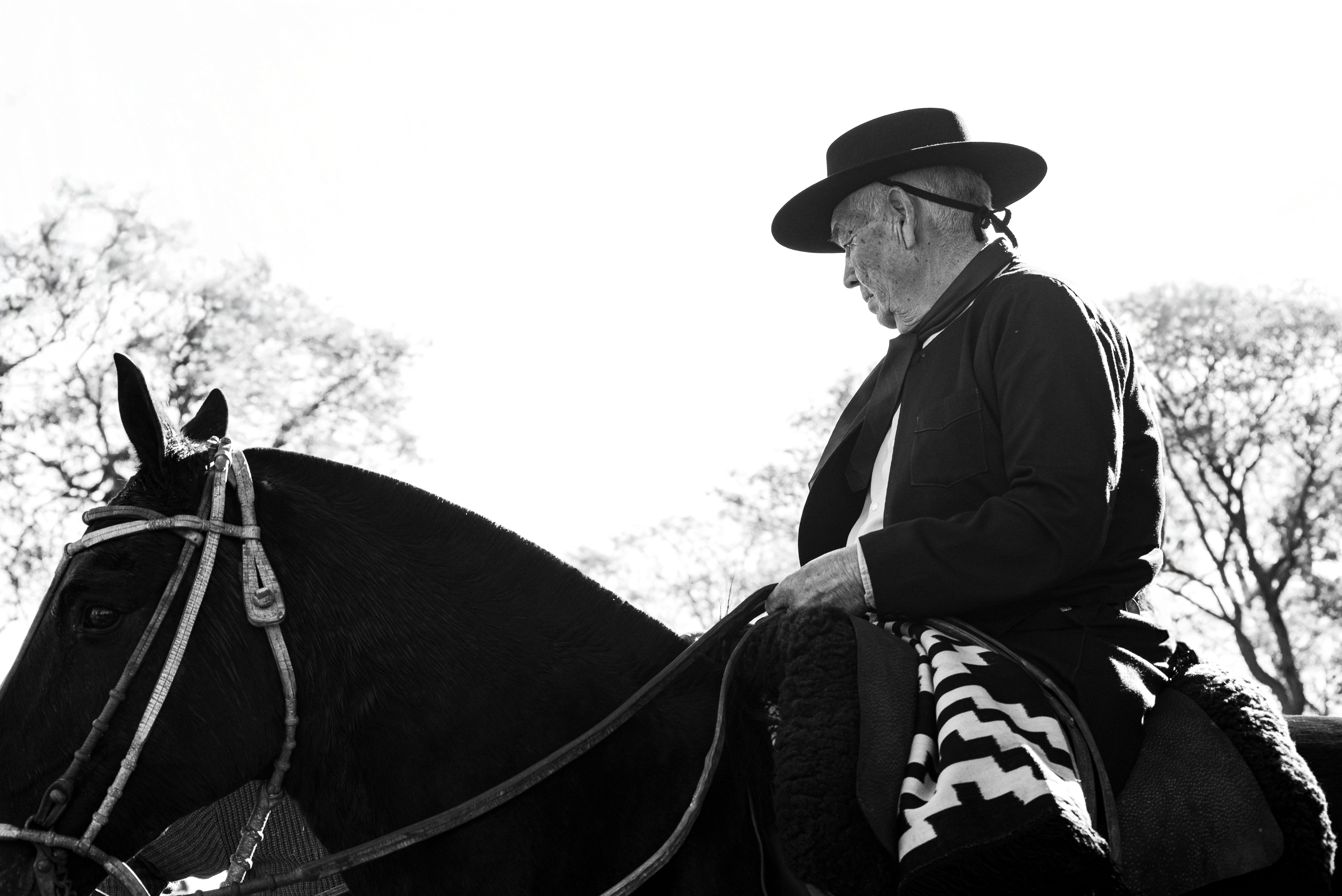 Black and white portrait of a gaucho on horseback in Chascomús, Argentina.