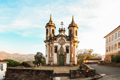 Free Beautiful baroque architecture of a church in Ouro Preto, Brazil, during daylight with people nearby. Stock Photo