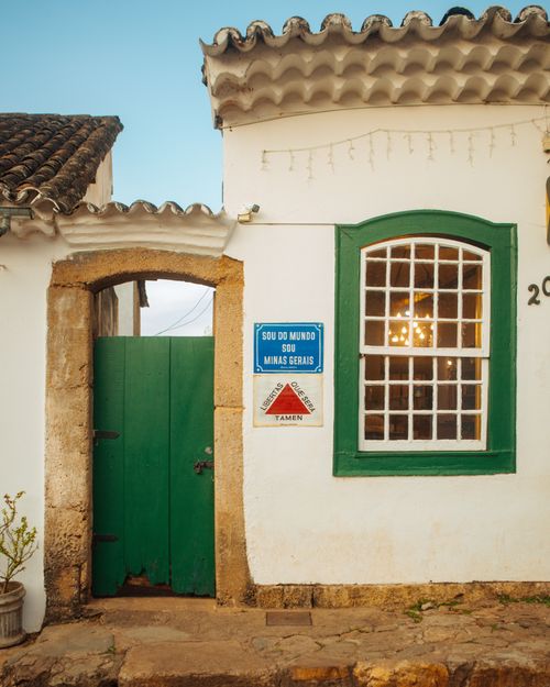 Free Colonial architecture with green accents and charming details in Minas Gerais, Brazil, at sunset. Stock Photo