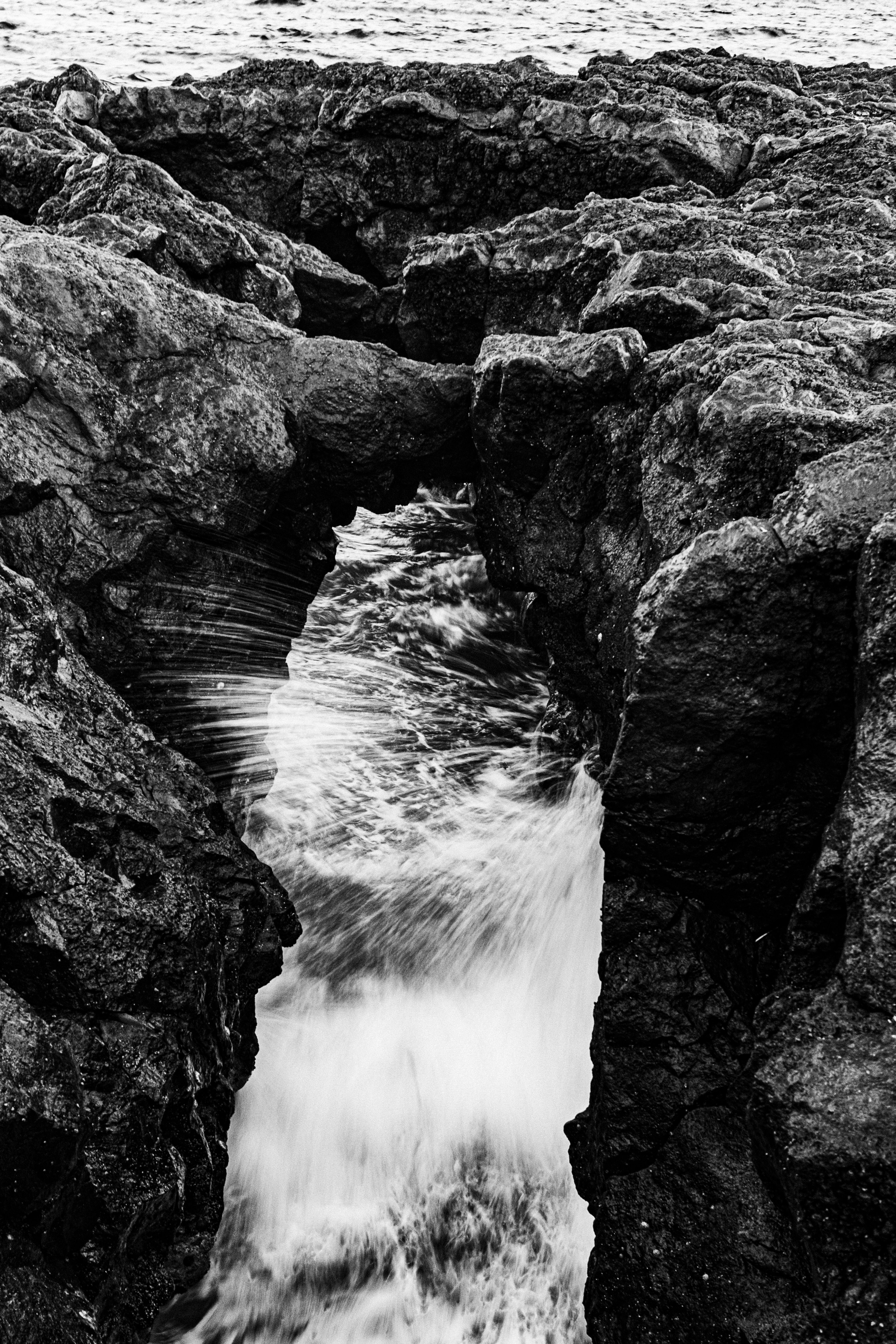 Dramatic Erosion at Ocean's Edge in Black and White · Free Stock Photo