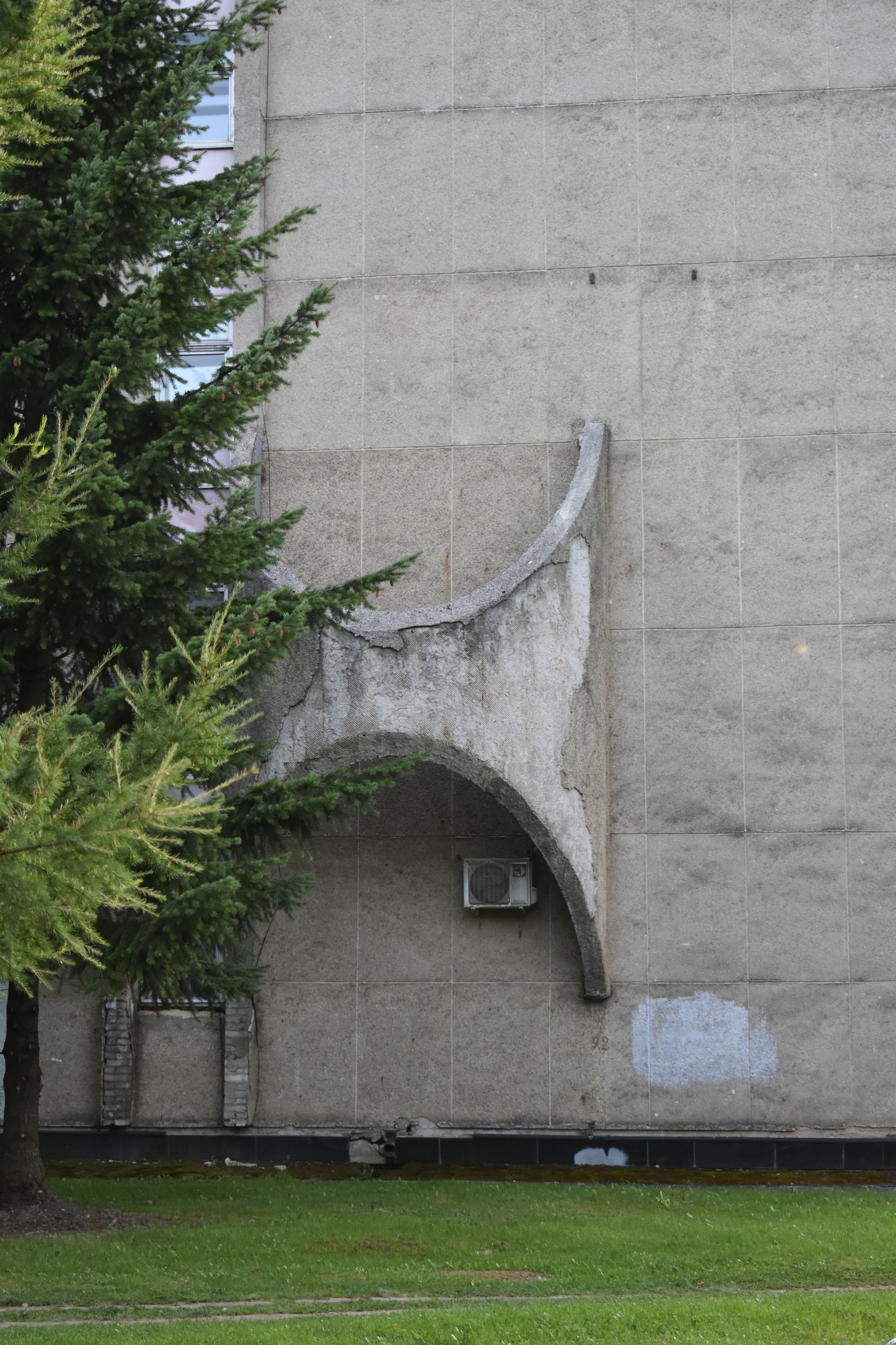 Unique Brutalist architecture with an abstract concrete sculpture on an exterior wall.. unique, brutalist, architecture