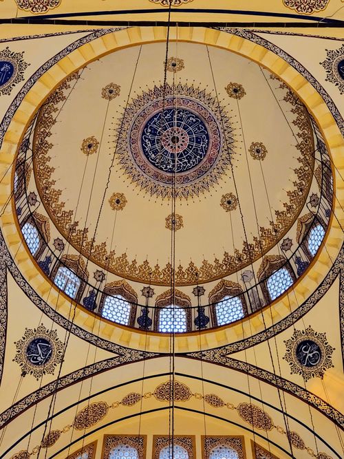 Free Stunning view of an ornate mosque dome featuring intricate geometric and floral designs. Stock Photo