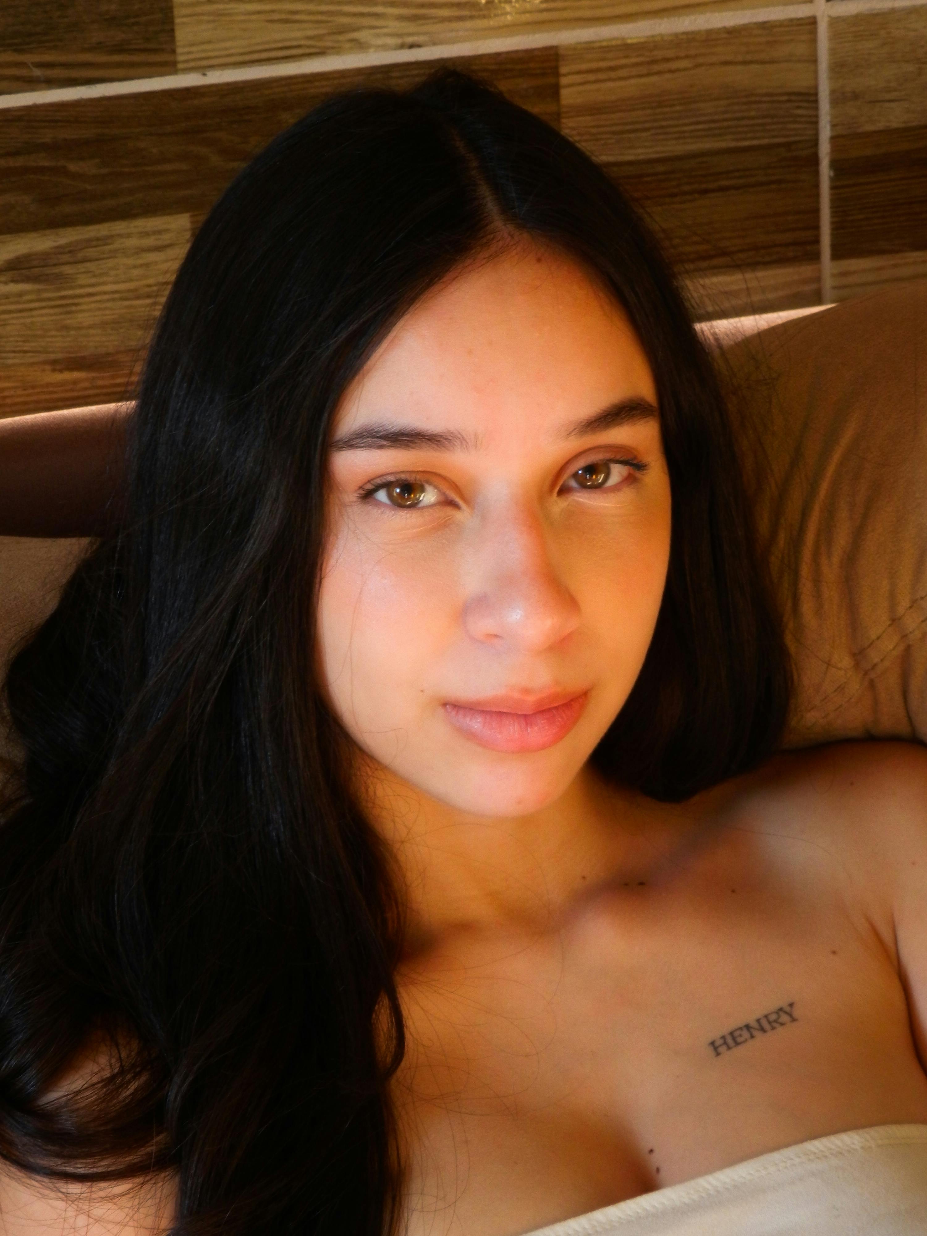 Intimate portrait of a woman with long dark hair, illustrating natural beauty.