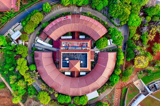 Drone shot of a circular building surrounded by greenery in Jawa Barat, Indonesia.