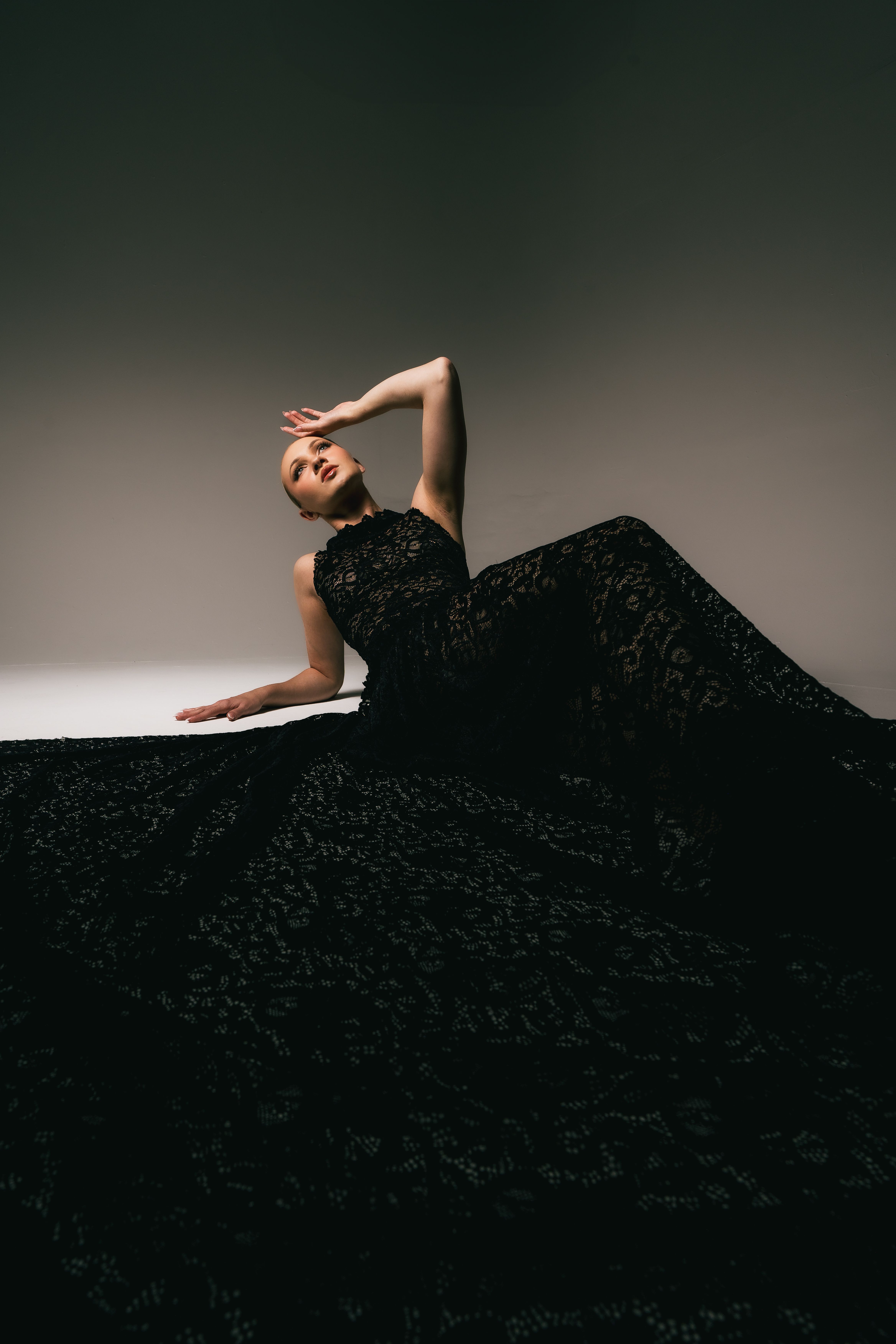 Woman in a black lace overlay dress