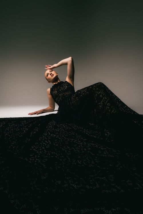 Woman in a black lace overlay dress