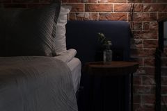 Intimate bedroom with brick wall and soft lighting, perfect for restful nights.