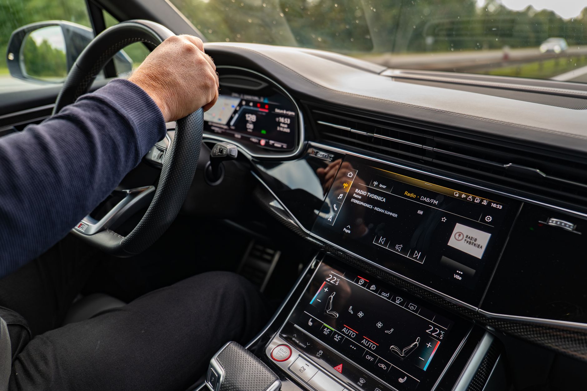 Interior view of a modern car being driven in Osijek, highlighting the dashboard and entertainment system.