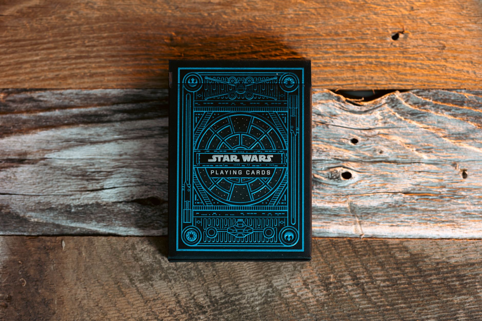 Blue Star Wars themed playing cards on a textured wooden surface.