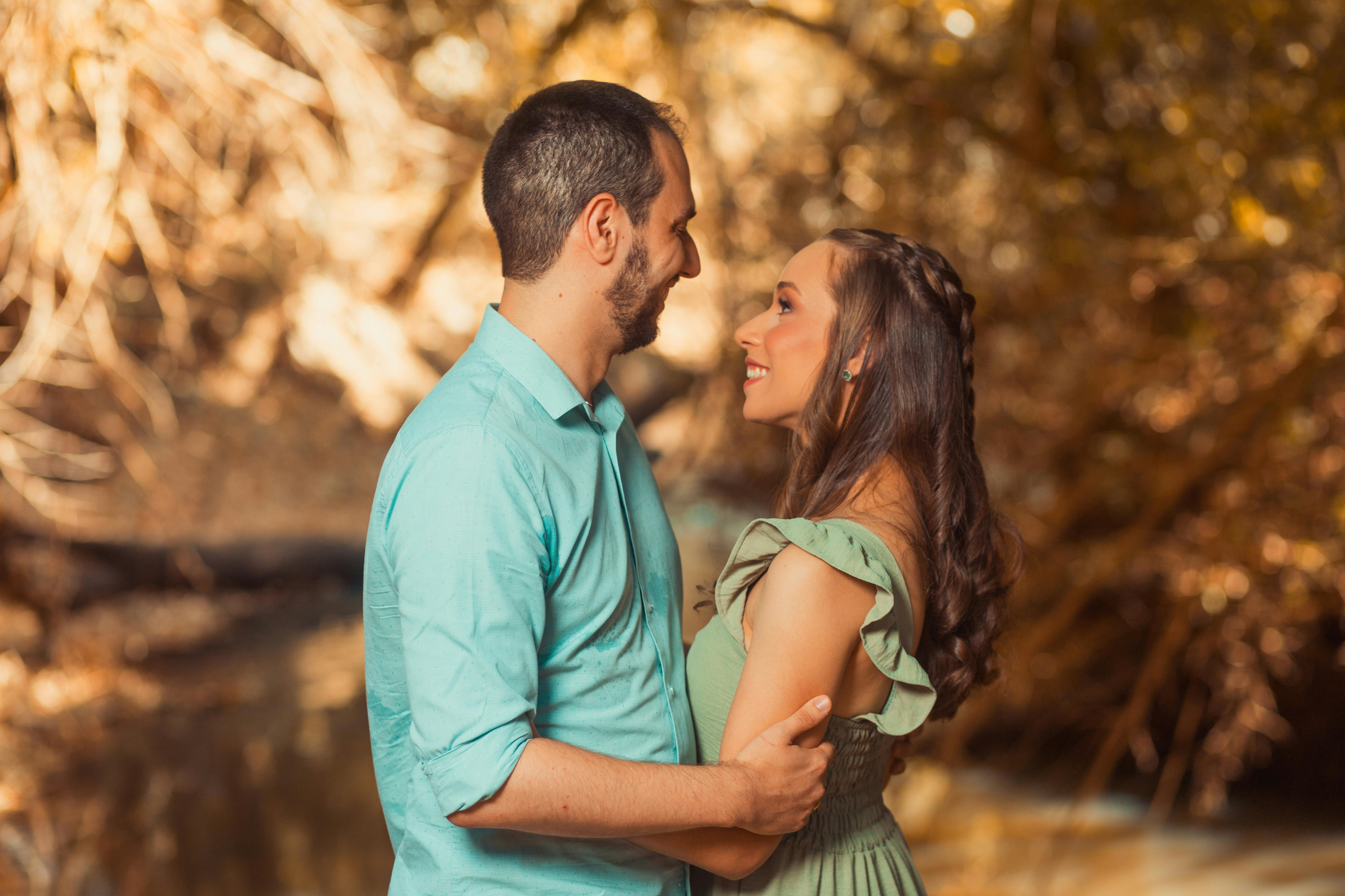 Lovers entwined in soft afterglow, rain-kissed window in background, peaceful surrender