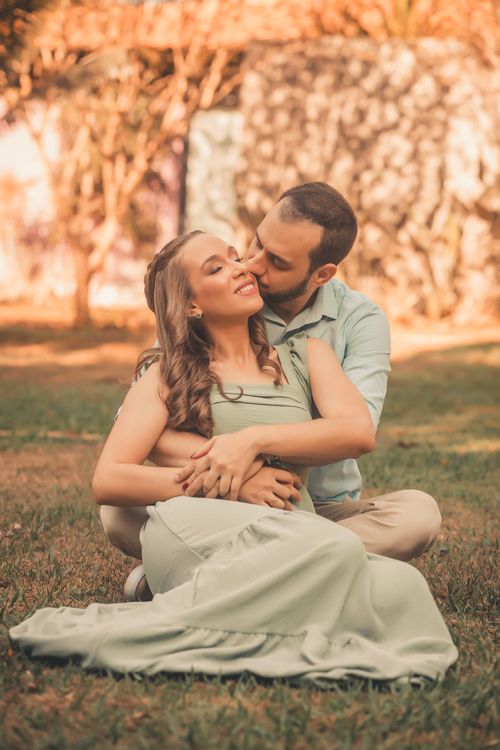 Free A loving couple enjoys a tender moment outdoors, surrounded by nature's warm hues. Stock Photo