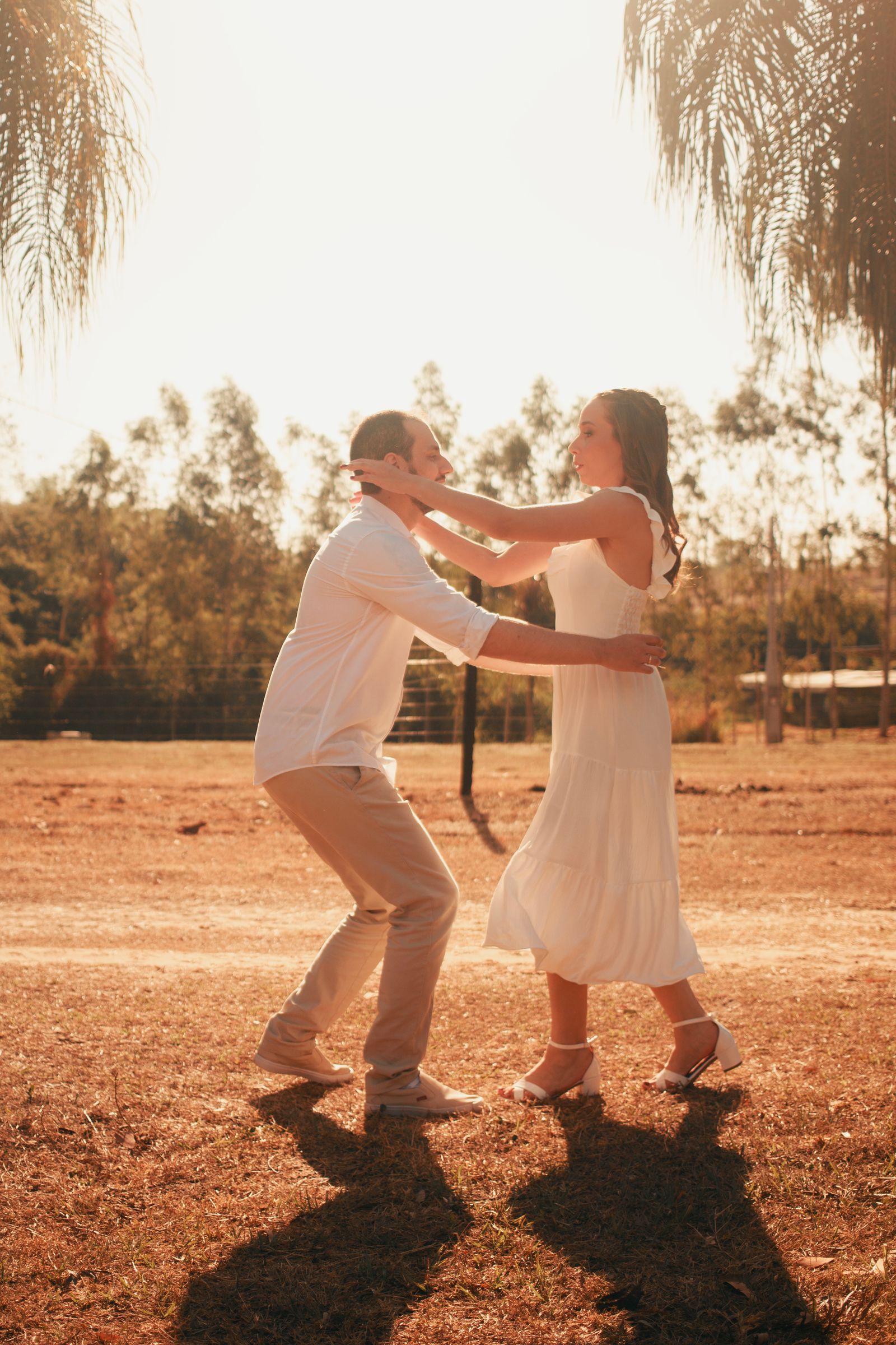 Bachata — couple dancing joyfully in a sunlit field.