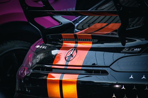 Free A detailed view of a luxury sports car with a vibrant stripe parked in Belgrade, Serbia. Stock Photo