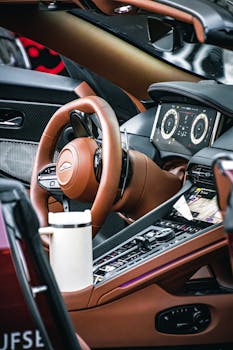Close-up of a luxury car interior focusing on the steering wheel and digital dashboard in Belgrade, Serbia.