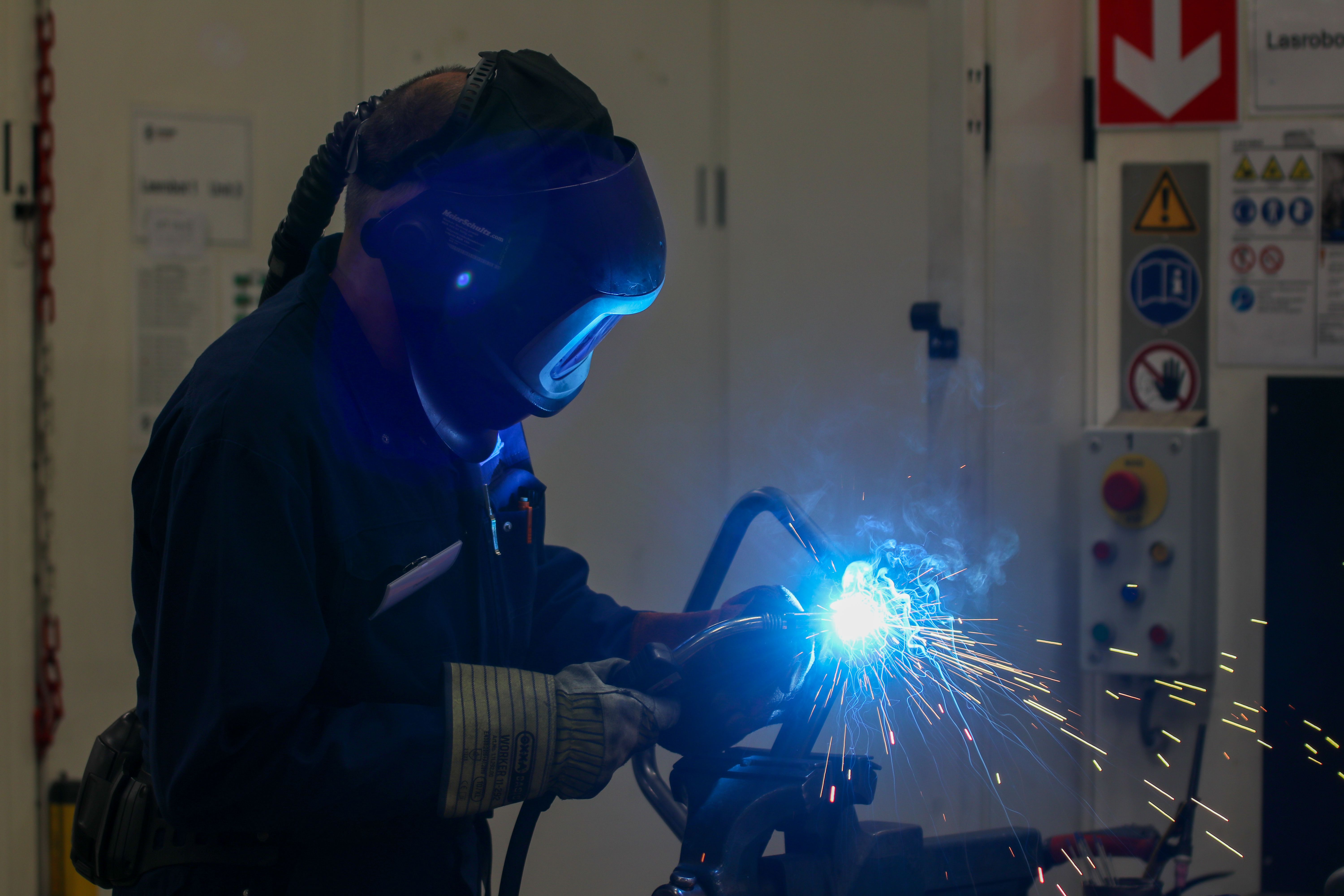A fabricator welding a metal assembly