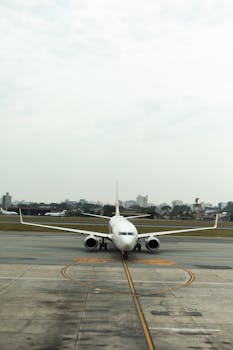 在跑道上滑行的飞机，其前视图展现城市天际线