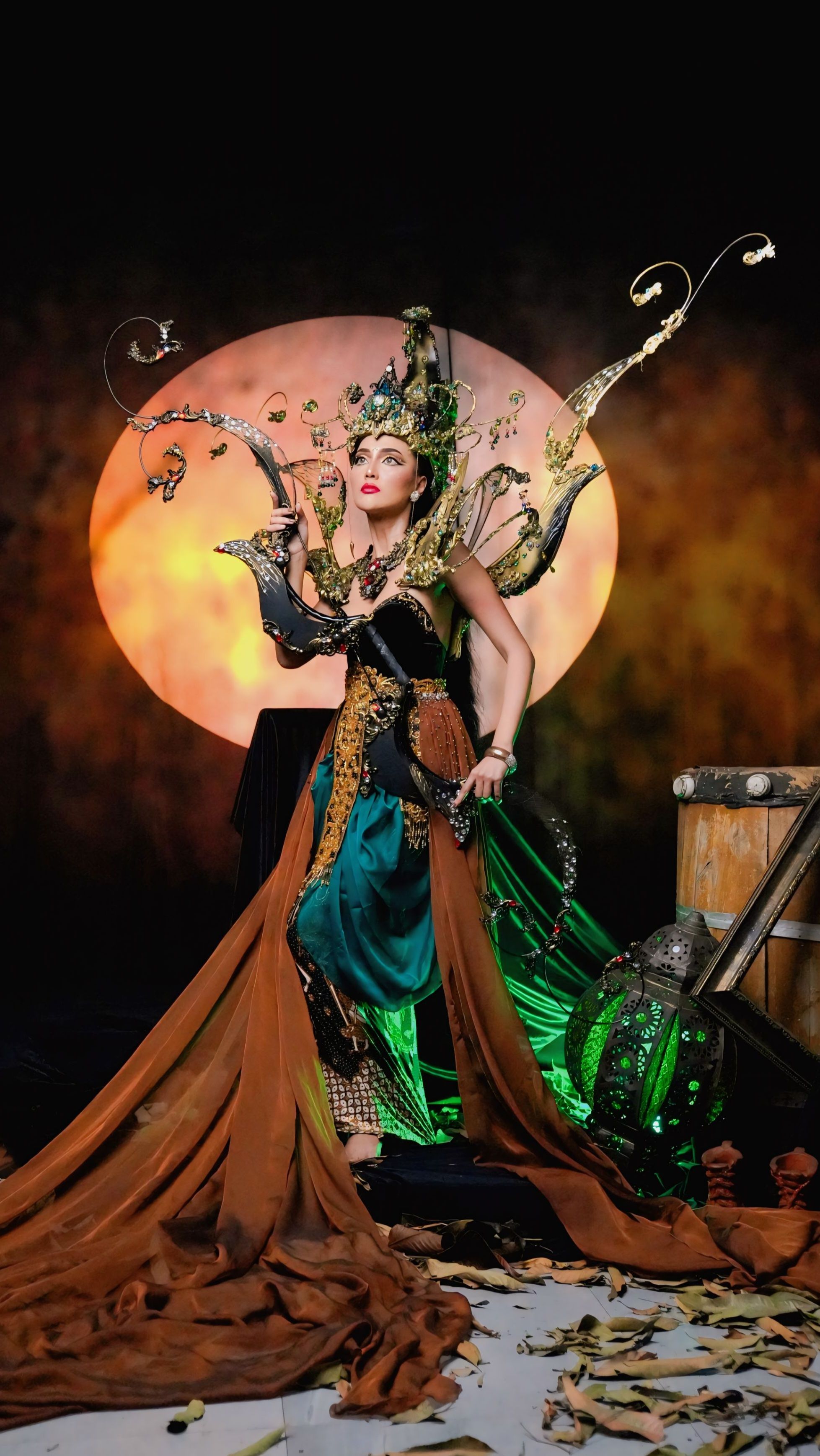 A person in elaborate traditional Indonesian costume poses in a dramatic setting, reflecting cultural heritage.