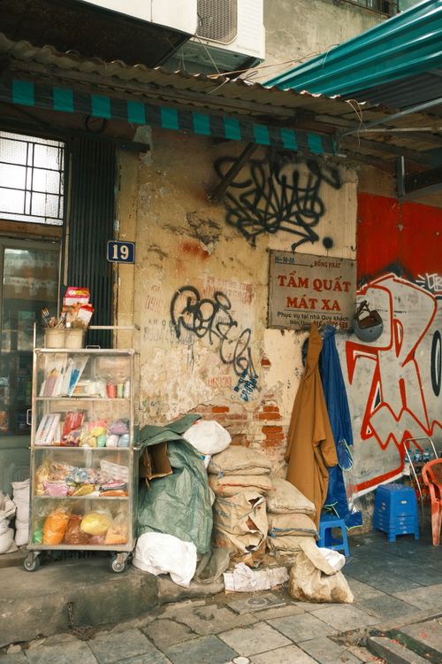 Free Vibrant urban scene featuring graffiti and market stores on a street corner in Japan. Stock Photo