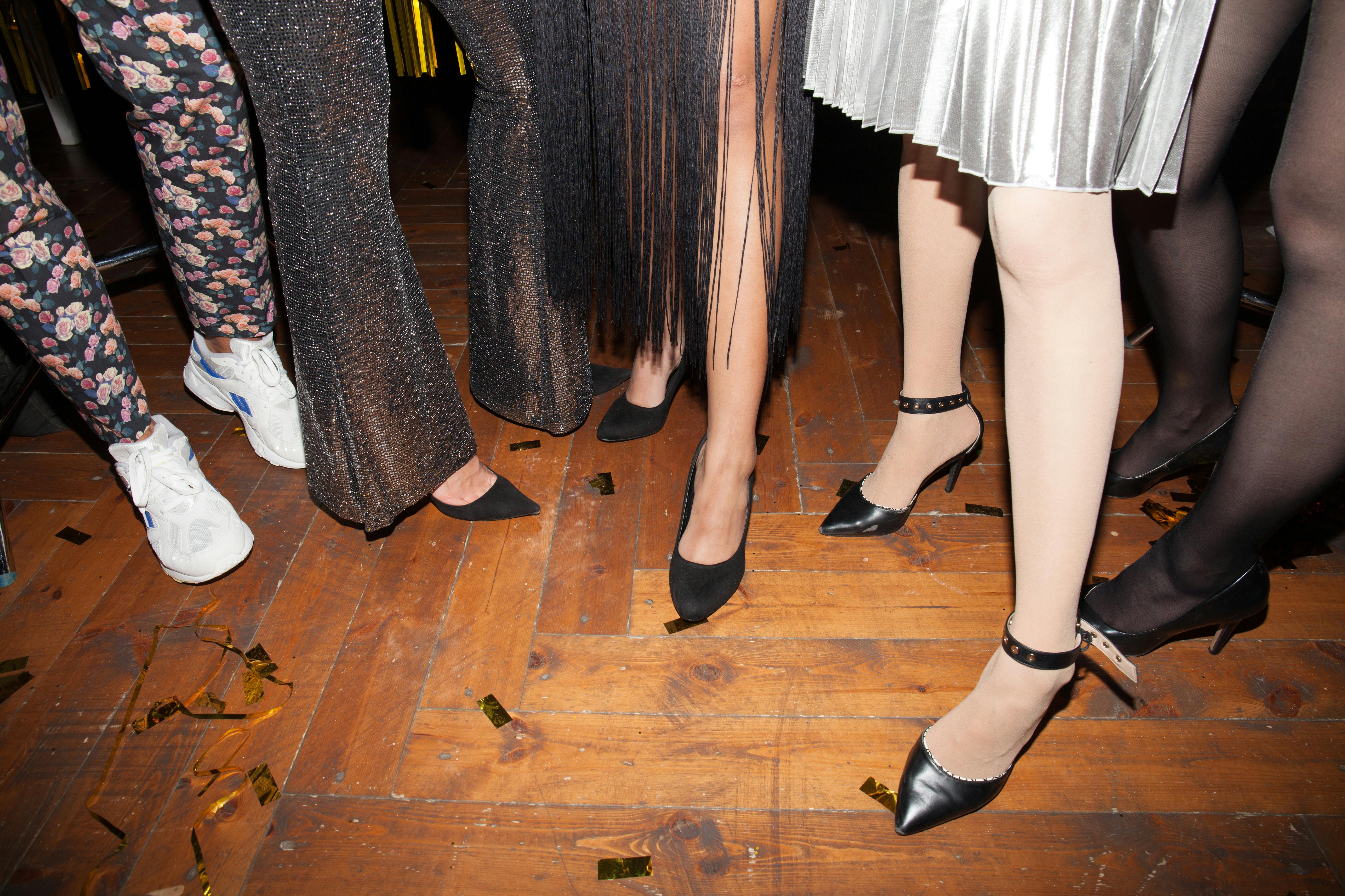 women wearing black high heels