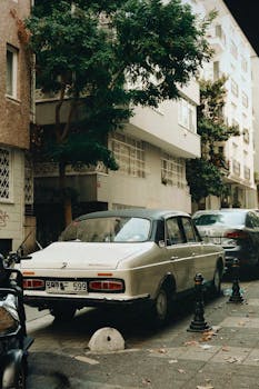 Classic car parked on a quiet city street, capturing an urban vintage feel.