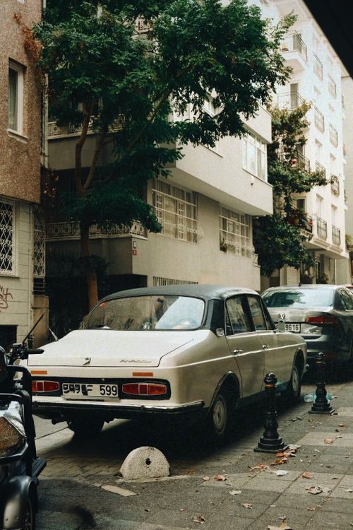 Free Classic car parked on a quiet city street, capturing an urban vintage feel. Stock Photo