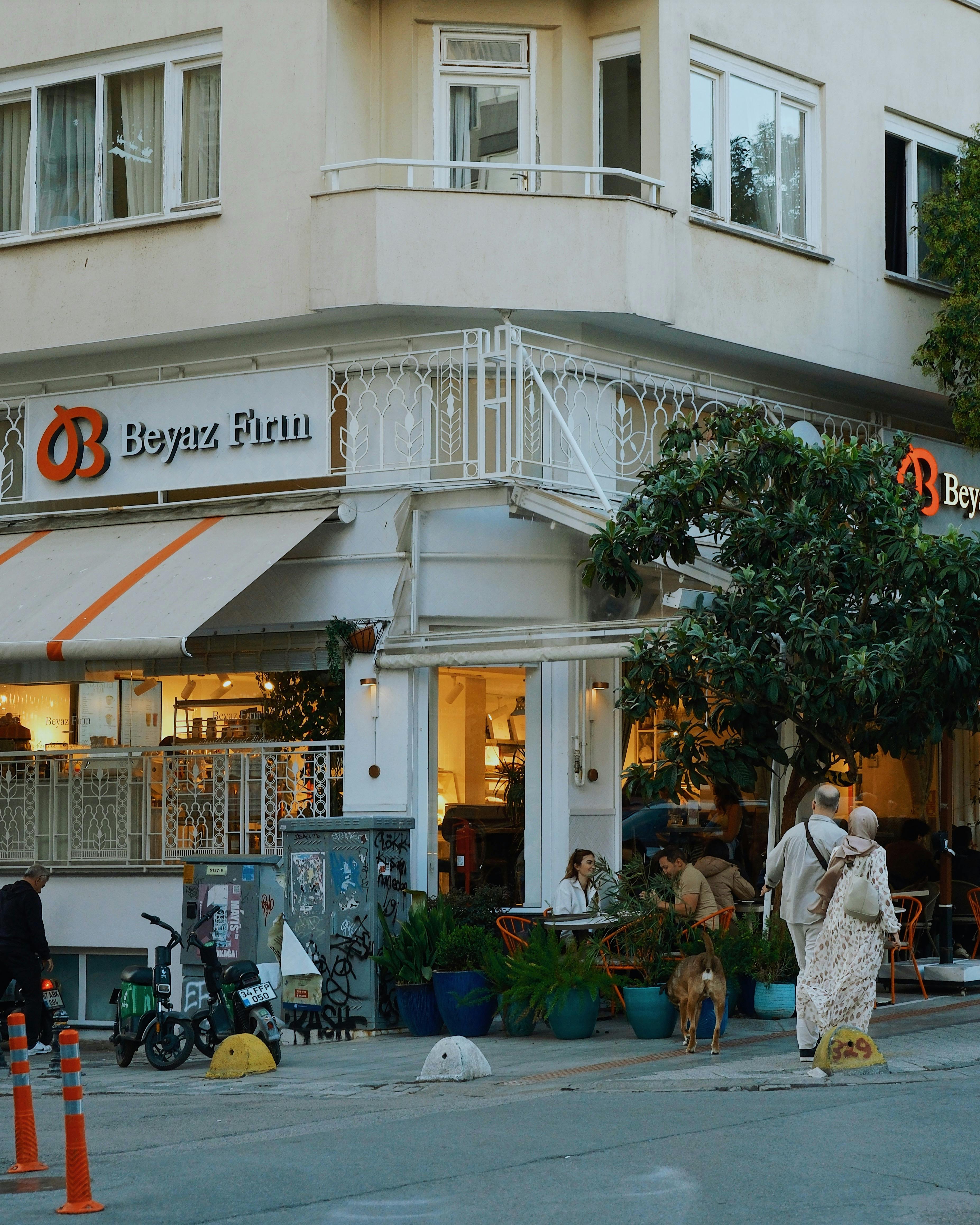 Corner cafe bustling with activity, perfect for a relaxed urban experience.
